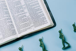Open Bible with Toy Soldiers  image 1