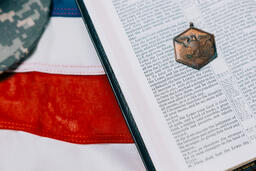 Open Bible with a Military Medallion on an American Flag  image 1