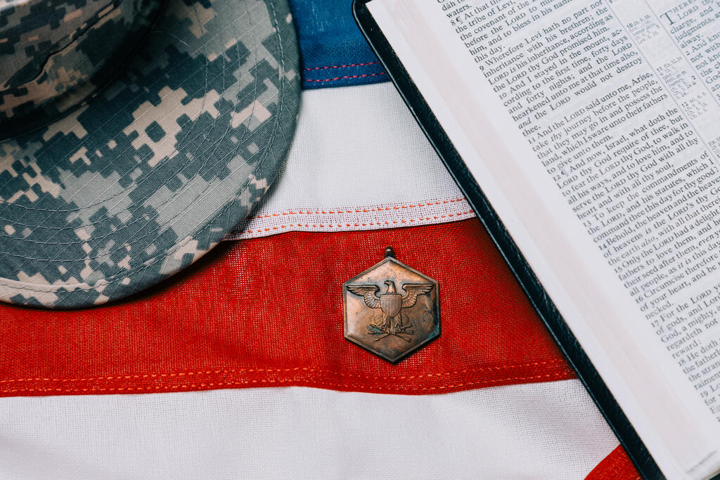 Military Hat and Open Bible on an American Flag large preview