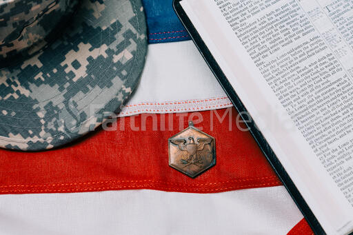 Military Hat and Open Bible on an American Flag