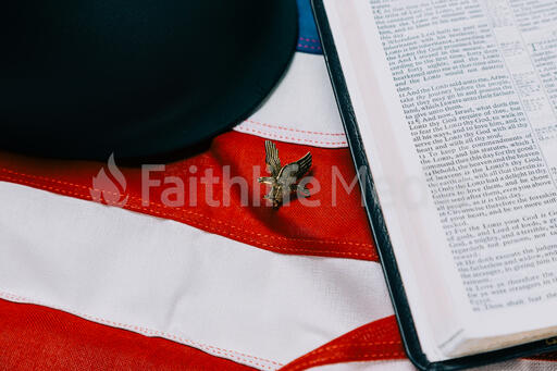 Military Helmet and Open Bible on an American Flag with a Military Medallion