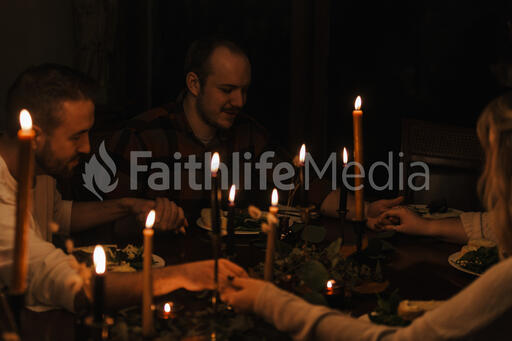 Small Group Praying Together Before a Meal