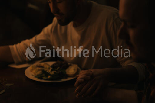 Small Group Praying Together Before a Meal