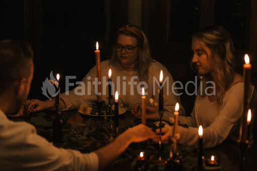Small Group Praying Together Before a Meal