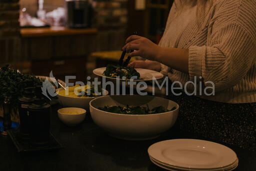 Woman Serving Up Salad