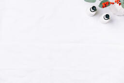 Christmas Florals and Taper Candles on a White Linen Tablecloth  image 1