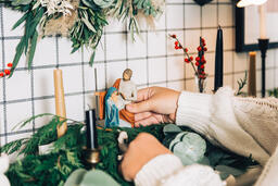 Woman Arranging the Nativity Scene  image 3