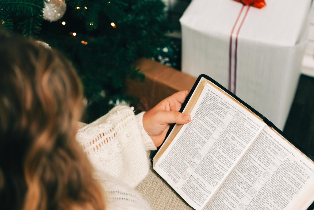 Woman Reading the Bible in Front of the Christmas Tree large preview