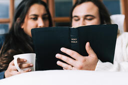 Husband and Wife Reading the Bible Together in Bed  image 2