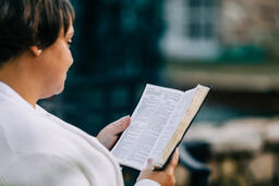 Woman Reading the Bible on the Patio Outside  image 2