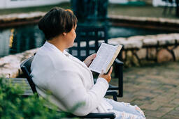 Woman Reading the Bible on the Patio Outside  image 3