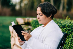 Woman Reading the Bible on the Patio Outside  image 4