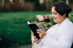 Woman Reading the Bible on the Patio Outside  image 3