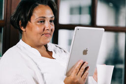 Woman Reading on a Tablet  image 1