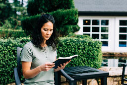 Woman Reading the Bible on the Patio Outside  image 1