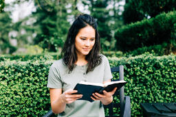 Woman Reading the Bible on the Patio Outside  image 1