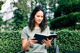Woman Reading the Bible on the Patio Outside  image 2
