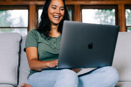 Woman Working on a Laptop and Smiling  image 4