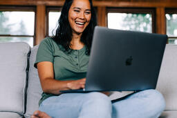 Woman Working on a Laptop and Smiling  image 6