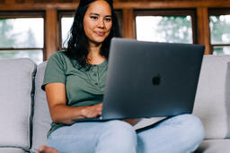 Woman Working on a Laptop and Smiling  image 2