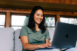 Woman Working on a Laptop and Smiling  image 3