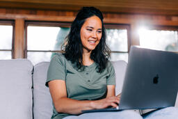 Woman Working on a Laptop and Smiling  image 5