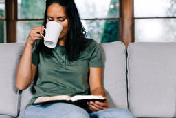 Woman Reading the Bible and Drinking Coffee  image 1