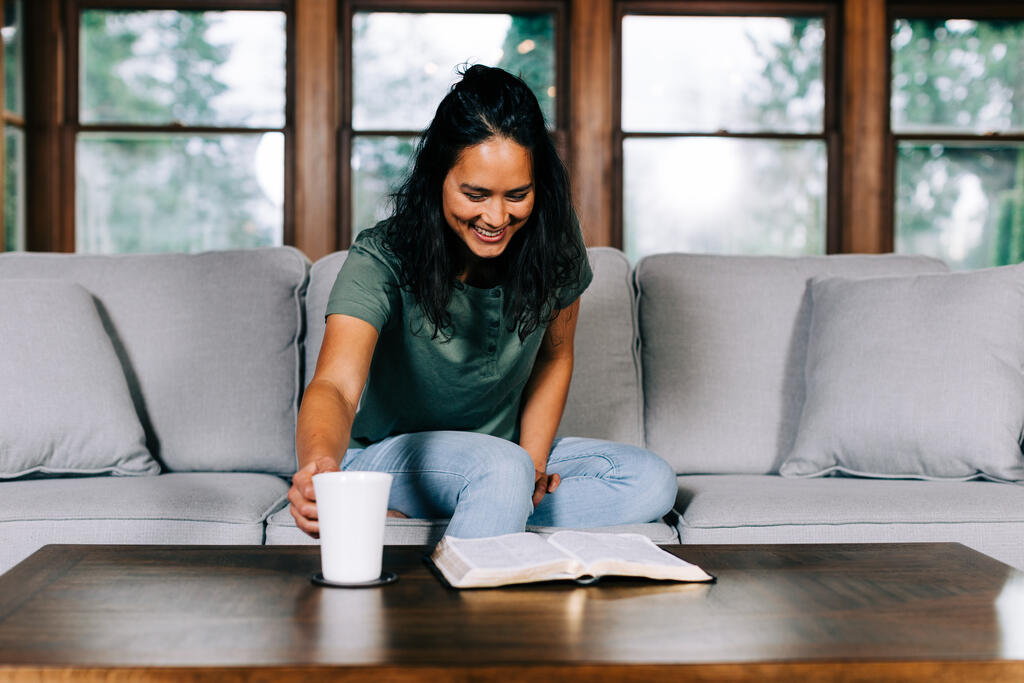 Woman Grabbing Her Cup of Coffee During Devotions large preview