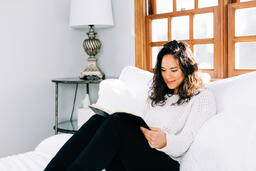 Woman Reading the Bible in Bed at Sunrise  image 2