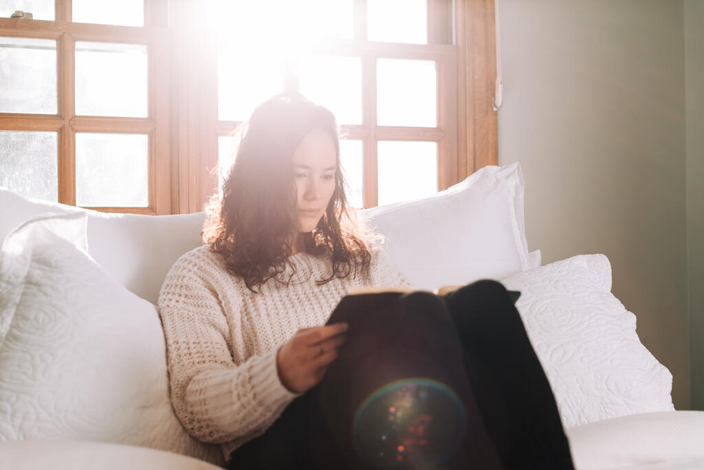 Woman Reading the Bible in Bed at Sunrise large preview