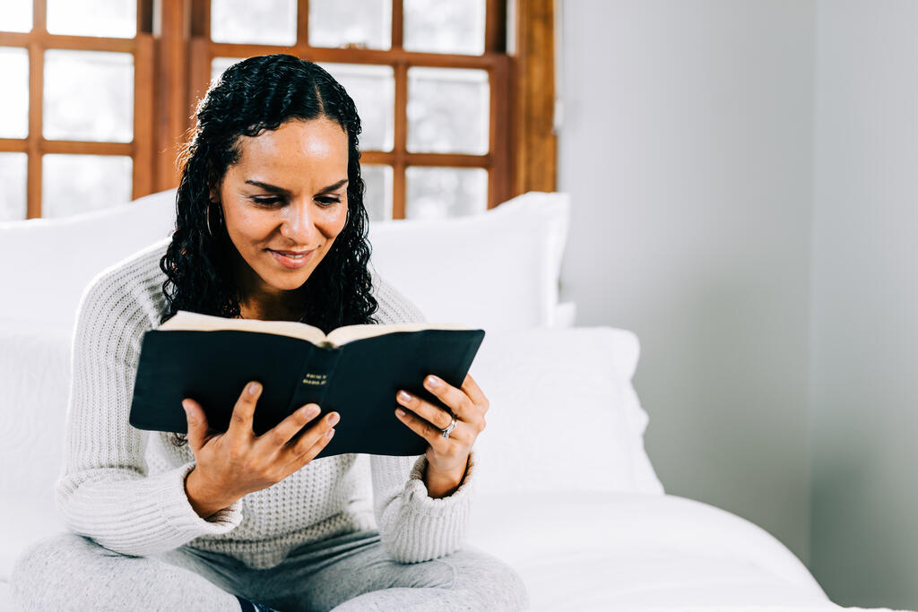 Woman Reading the Bible in Bed at Sunrise large preview