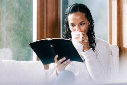 Woman Reading the Bible with a Cup of Coffee  image 1