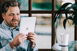 Man Reading on a Tablet  image 3