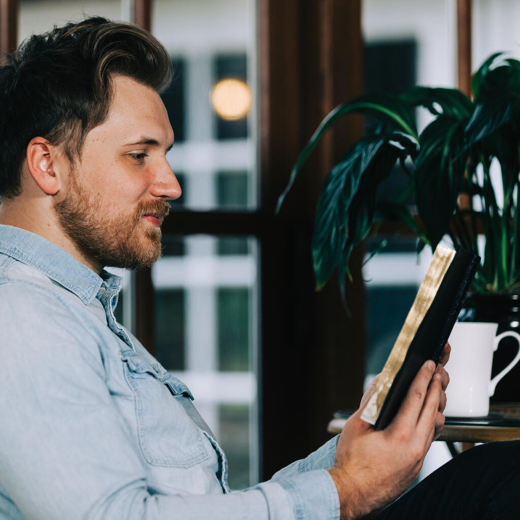 Man Reading the Bible with a Cup of Coffee large preview