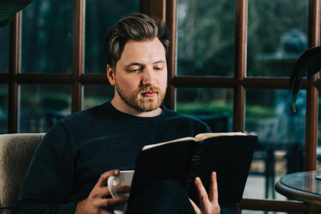 Man Reading the Bible with a Cup of Coffee large preview
