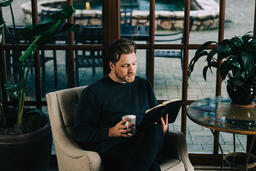 Man Reading the Bible with a Cup of Coffee  image 1