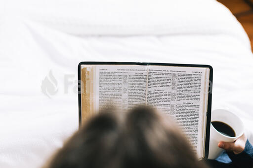 Husband and Wife Reading the Bible Together in Bed