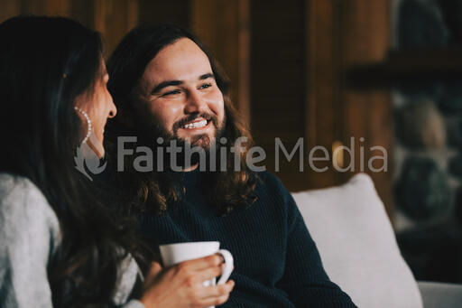 Husband and Wife Drinking Coffee and Laughing Together