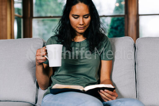 Woman Reading the Bible and Drinking Coffee