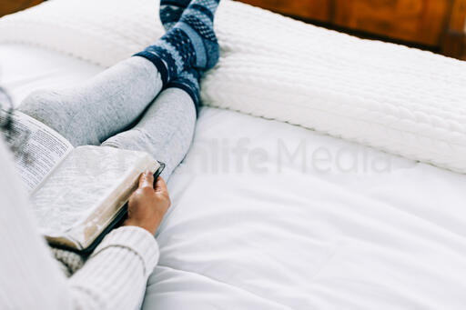 Woman Reading the Bible in Bed