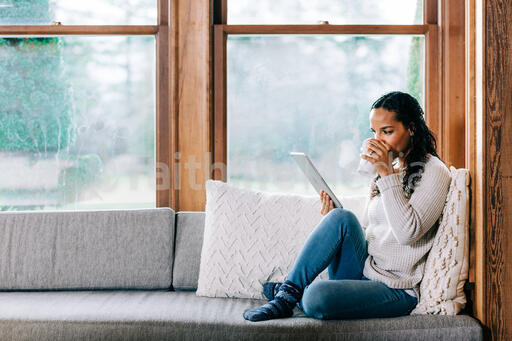 Woman Reading on a Tablet