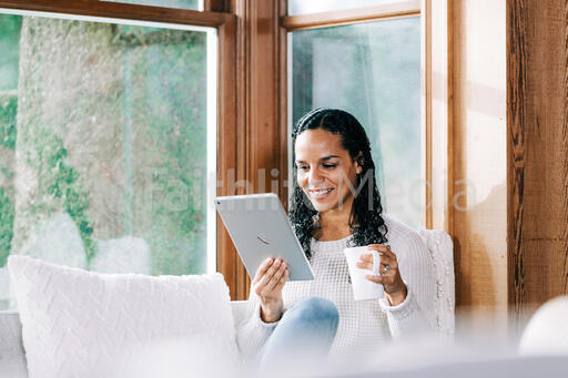 Woman Reading on a Tablet
