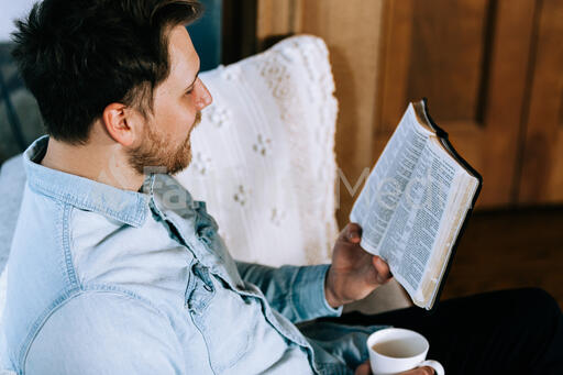 Man Reading the Bible with a Cup of Coffee
