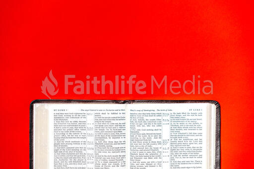 Open Bible on Red Background