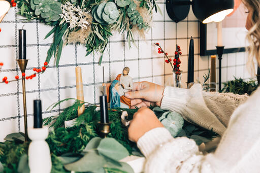 Woman Arranging the Nativity Scene