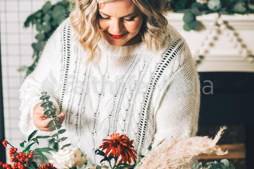 Woman Arranging Christmas Florals