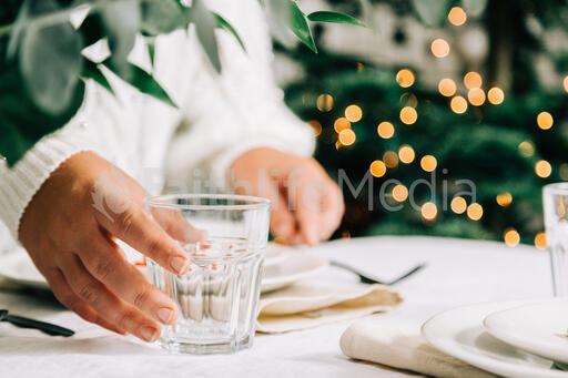 Woman Setting the Table for Christmas Dinner