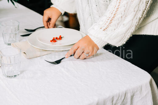 Woman Setting the Table for Christmas Dinner