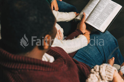 Family Reading the Bible Together at Christmastime