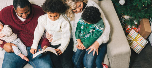 Family Reading the Bible Together at Christmastime